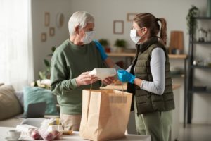 Volunteer buying food for senior people
